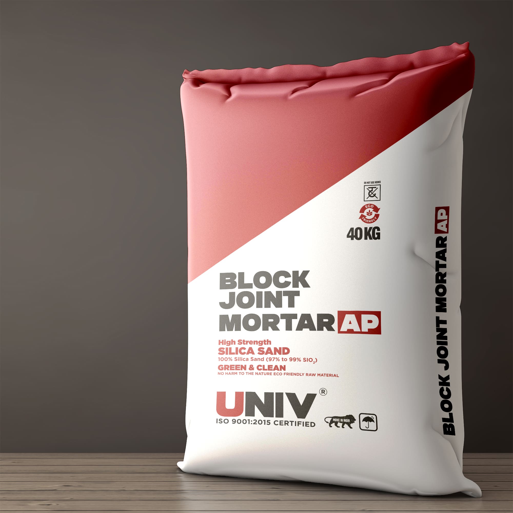 Univ - Bag Packaging: Univ Block Joint Mortar AP 40 kg bag in maroon and white, on a wooden floor against a grey wall