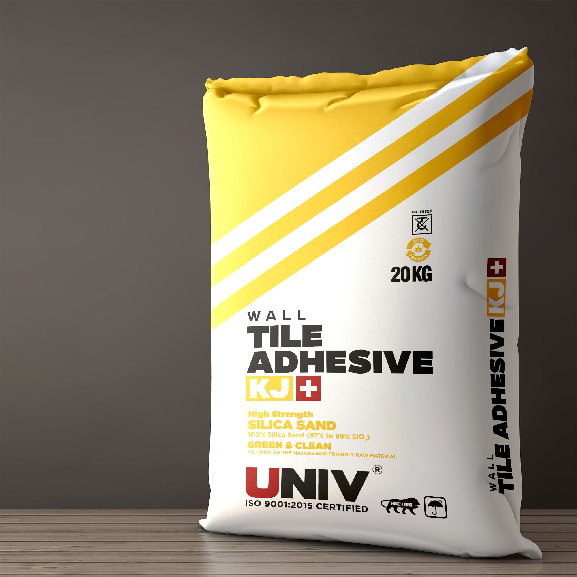 Univ - Bag Packaging: Univ Wall Tile Adhesive KJ 20 kg bag in yellow and white, on a wooden floor against a grey wall