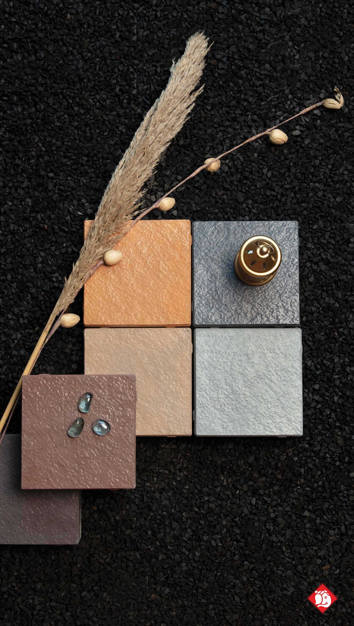 Vinayak Sanitarywares & Tiles: Square tile samples in orange, beige, grey and brown with dried pampas grass on black